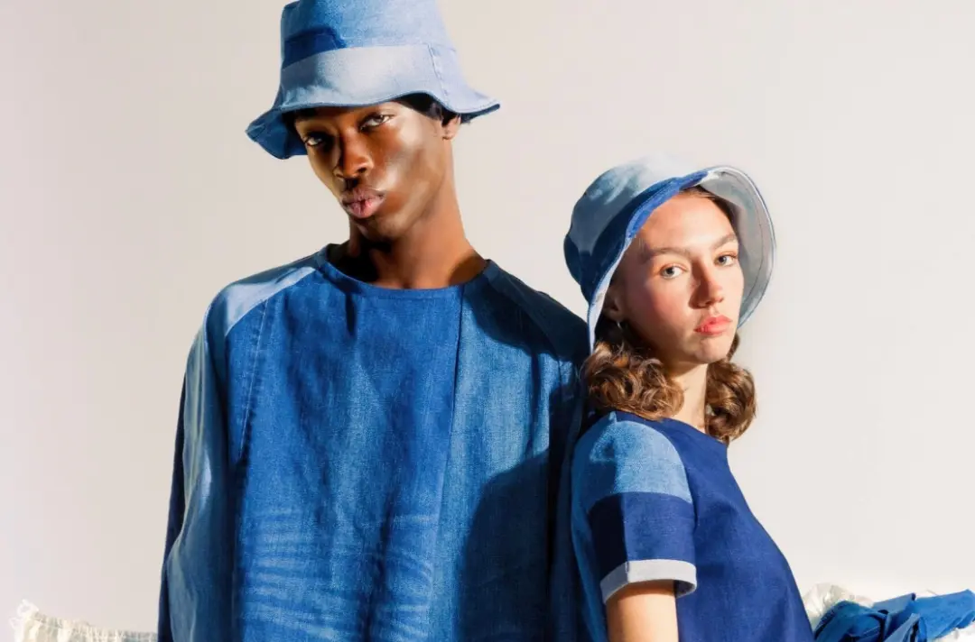 A photo shows two people posing in up-cycled denim clothing.
