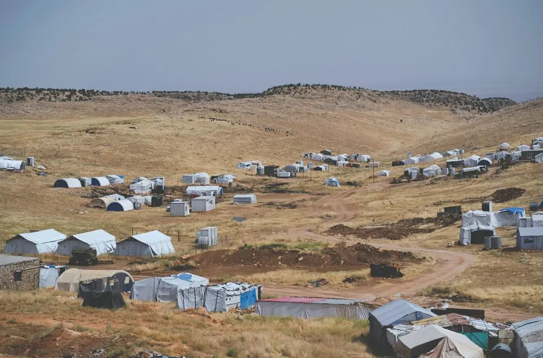 A refugee camp in a barren landscape.