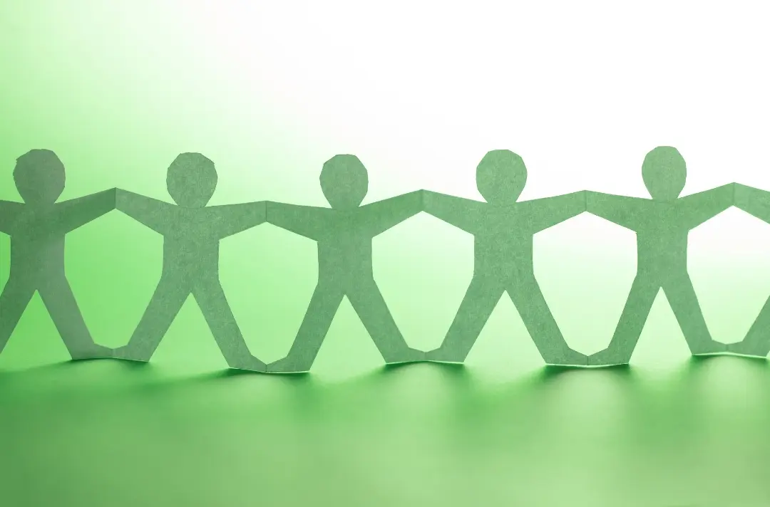A photo shows a paper chain of people.