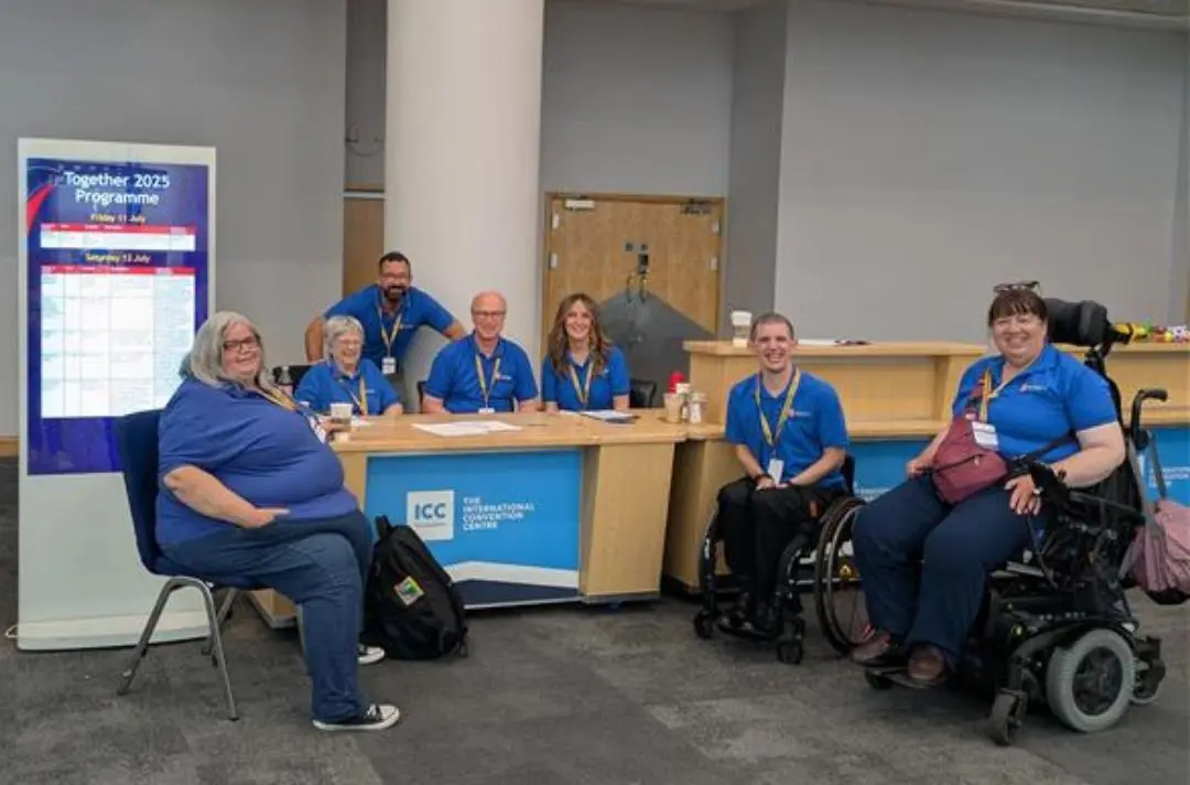 A photo of the here to help volunteers at Together 2025 by the welcome desk