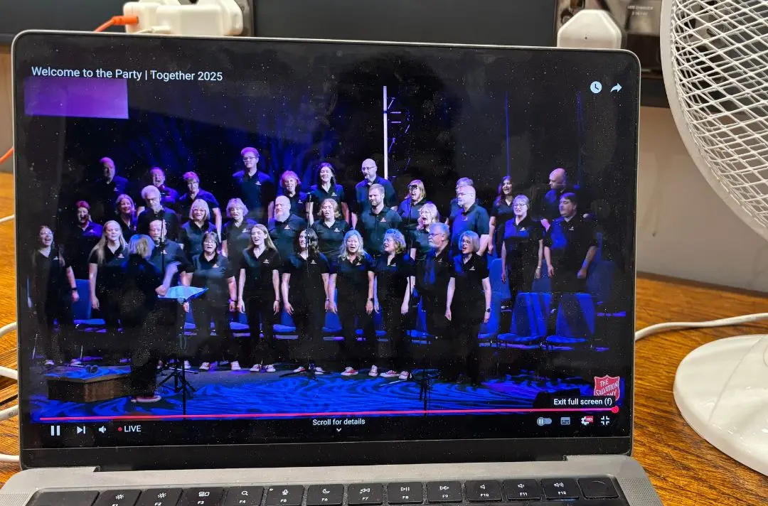 A computer showing the Canadian Staff Songsters on the Together 2025 livestream