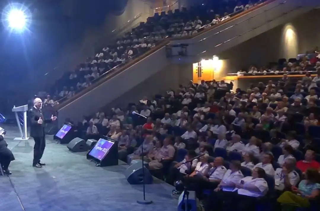 The General preaches on the platform to a capacity congregatoin