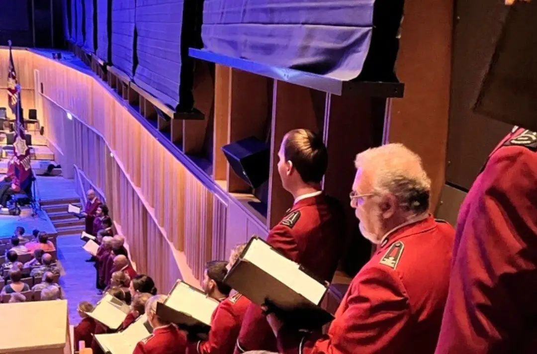 A photo of songsters singing around the audience at Together 2025