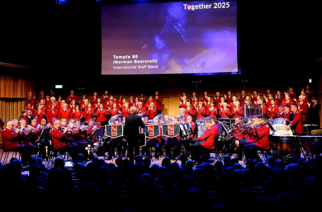 A photo shows the International Staff Band and International Staff Songsters performing on Friday at Together 2025.