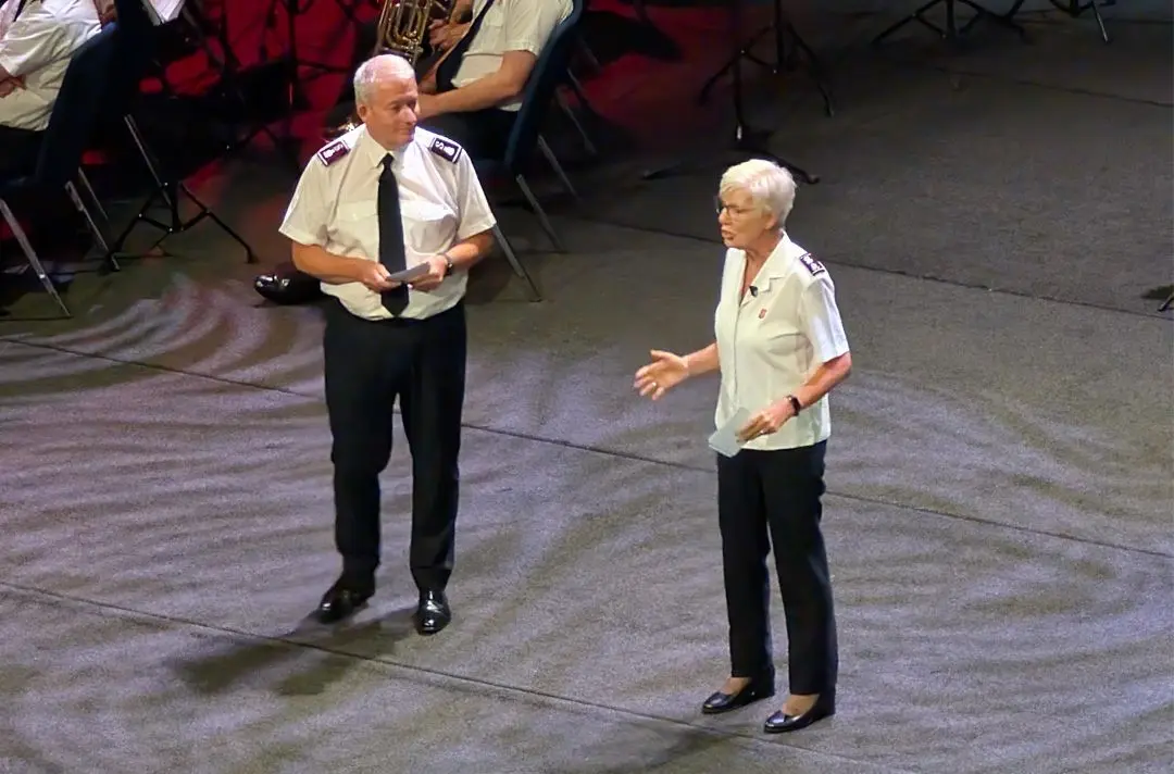 Paul and Jenine Main speaking on stage