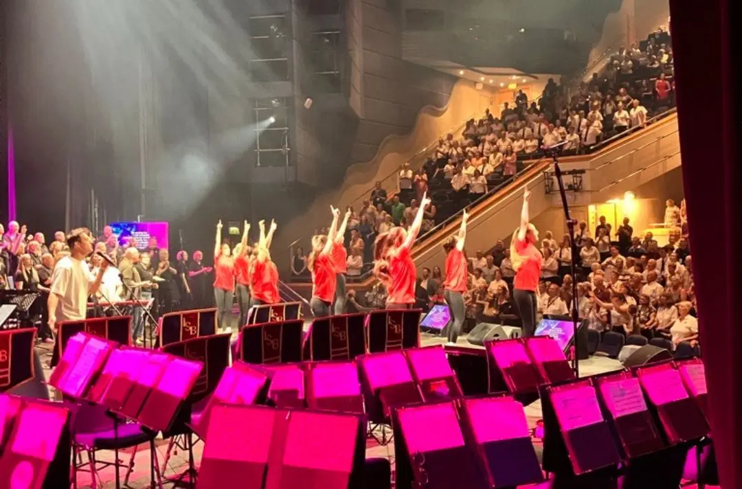 A photo from backstage at Together 2025 of people dancing and worshipping