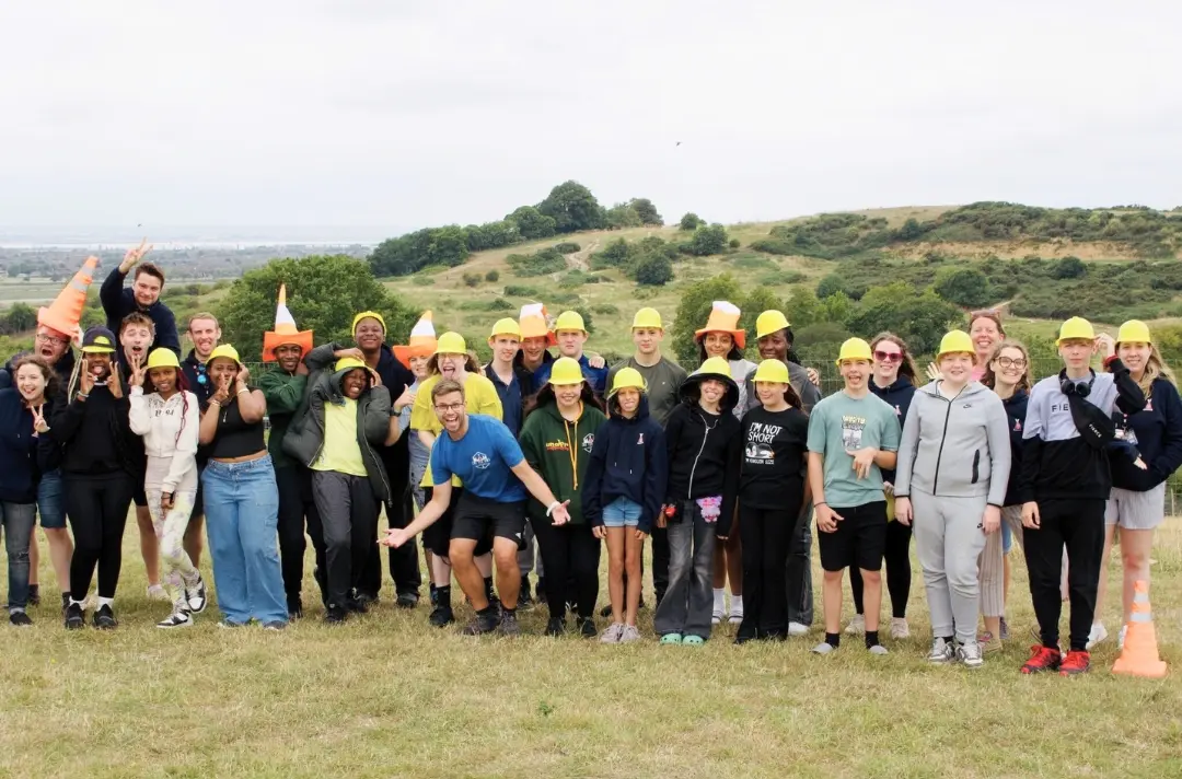 A photo shows summer camp delegates gathered for a group picture.