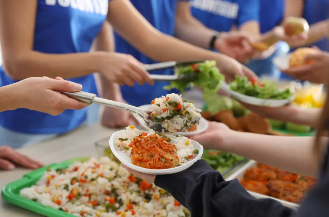 A photo shows people sharing food.