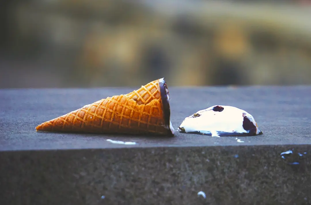 A photo shows a dropped ice cream cone.