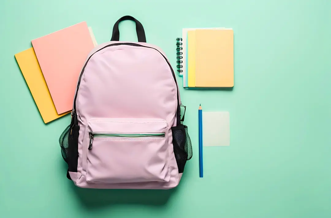 A photo shows a backpack and school supplies against a green background.