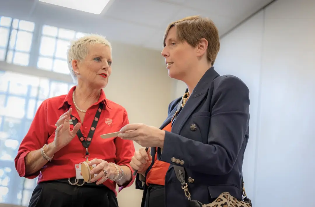 A photo depicts Kathy Betteridge talking to Jess Phillips.