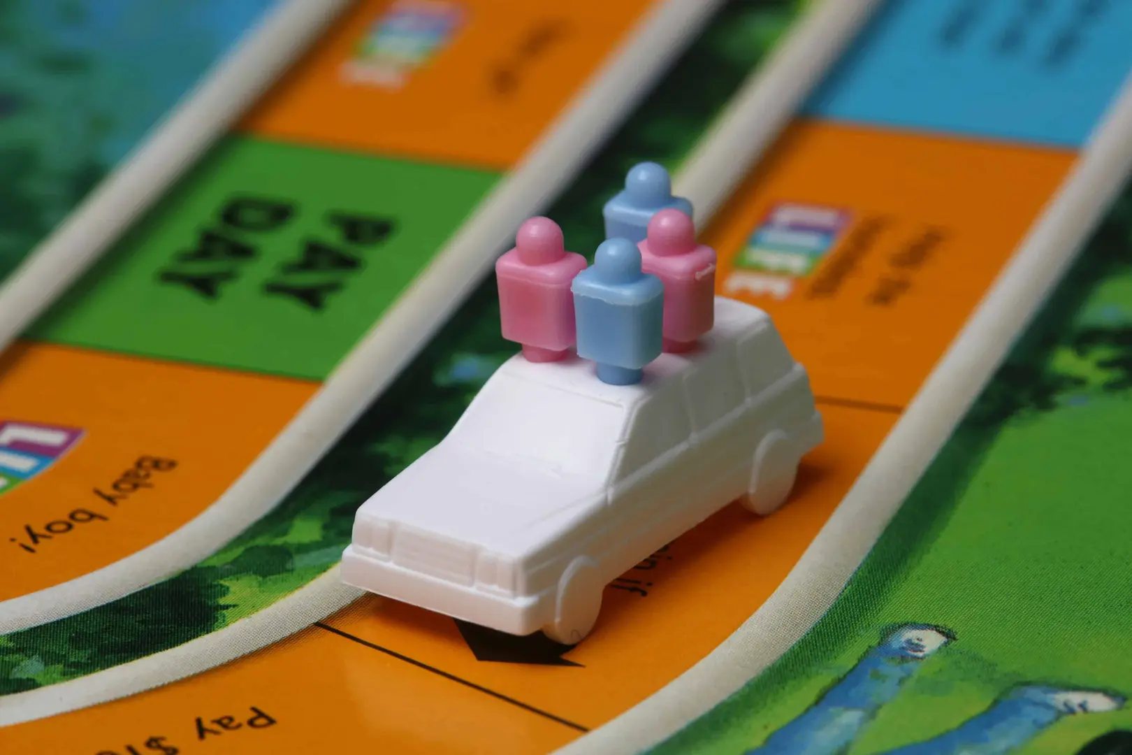A closeup photo of a toy car from the Game of Life Boardgame