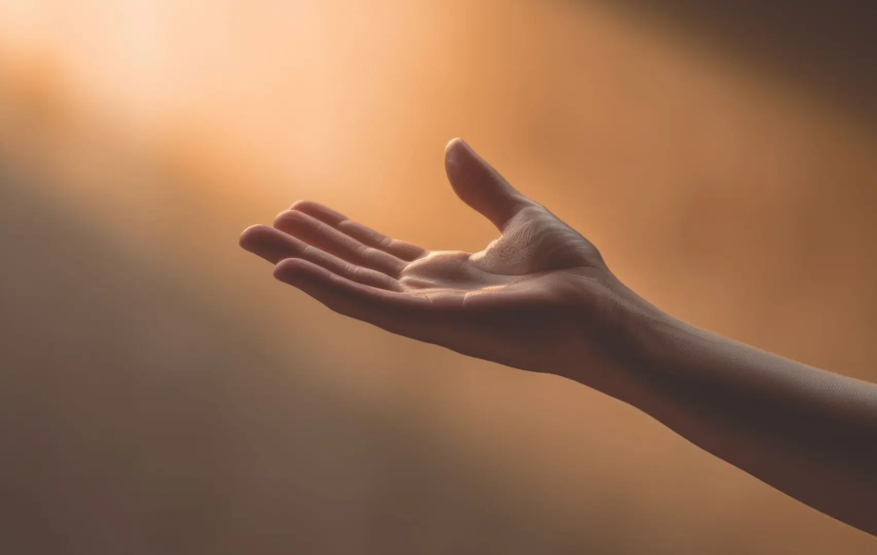 Hand reaching out towards a warming light.