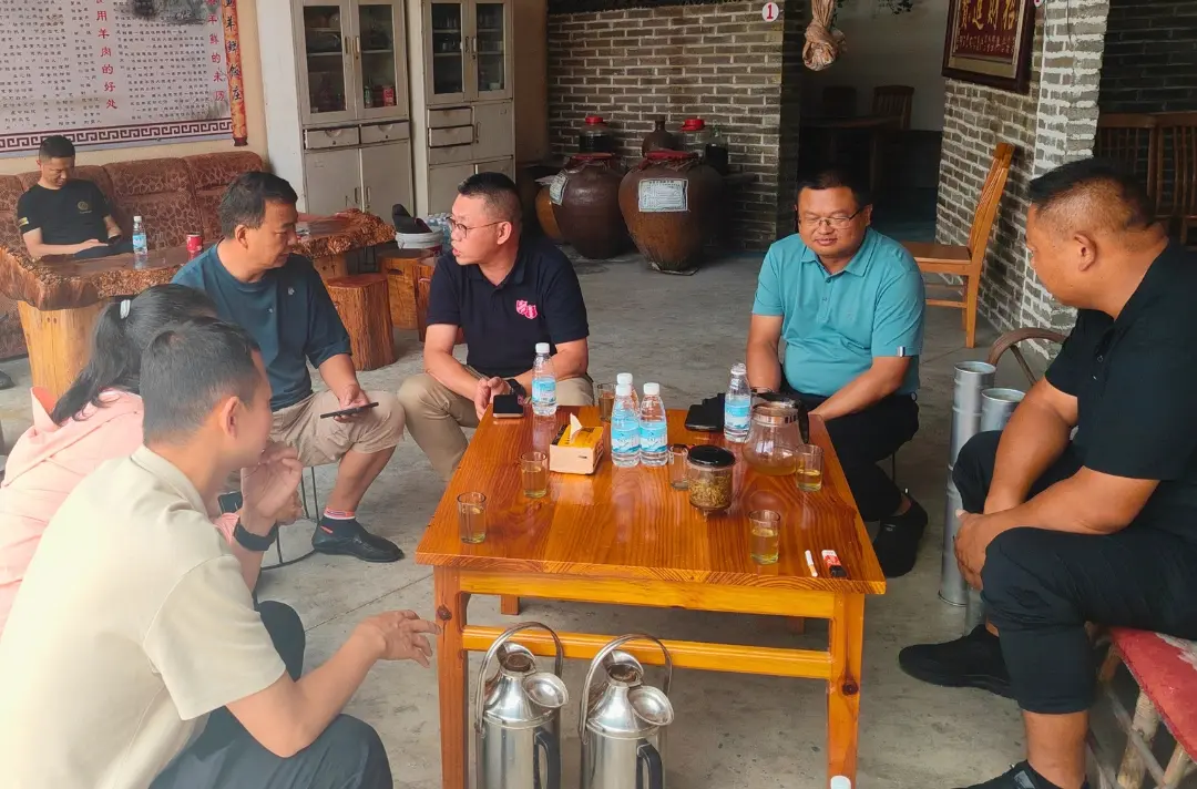 A photo shows people gathered around tables chatting.