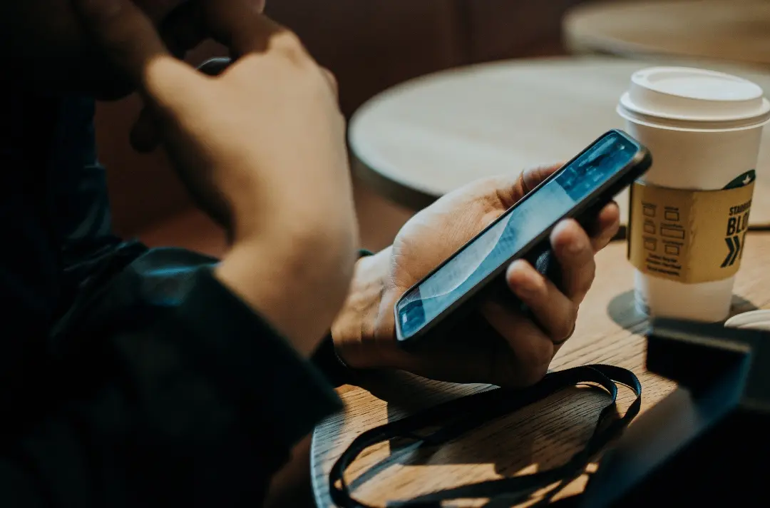 A photo shows someone holding a phone.