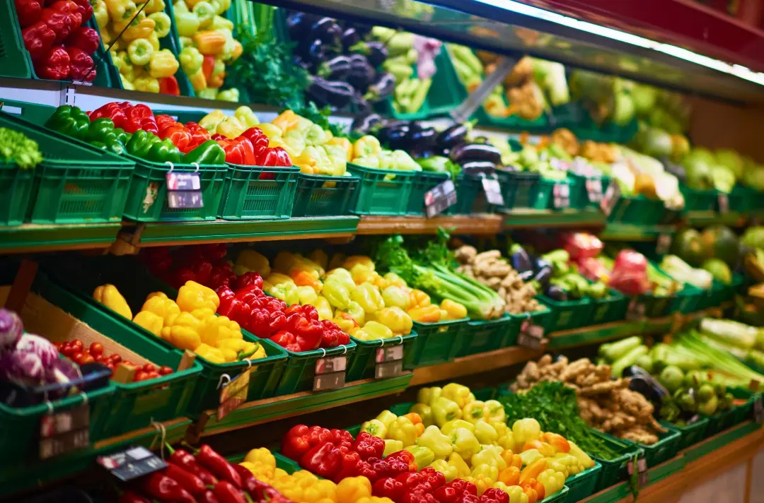 A supermarket shows the fruit and vegetable section of a supermarket.