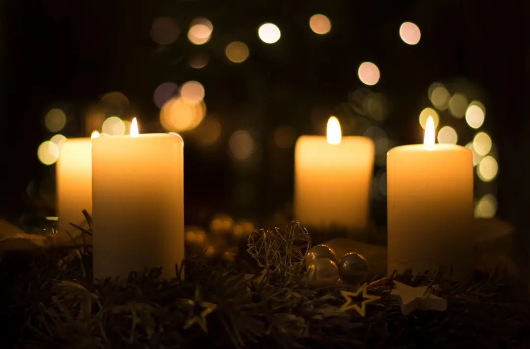 A closeup picture of some lit candles