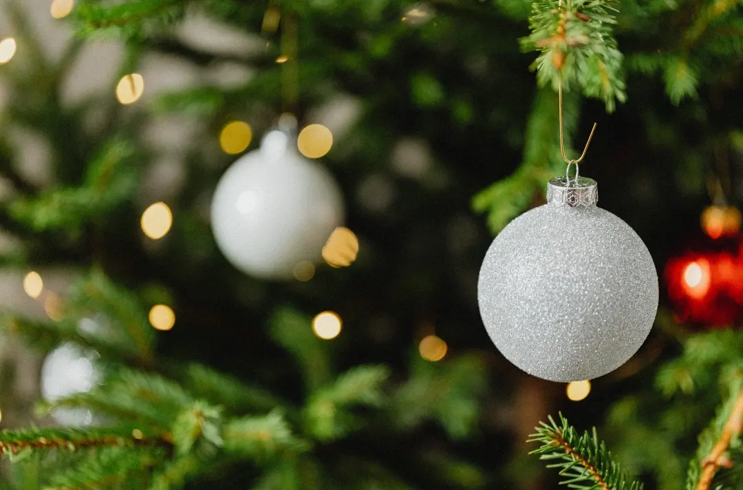 A closeup photo of a Christmas tree with decorations