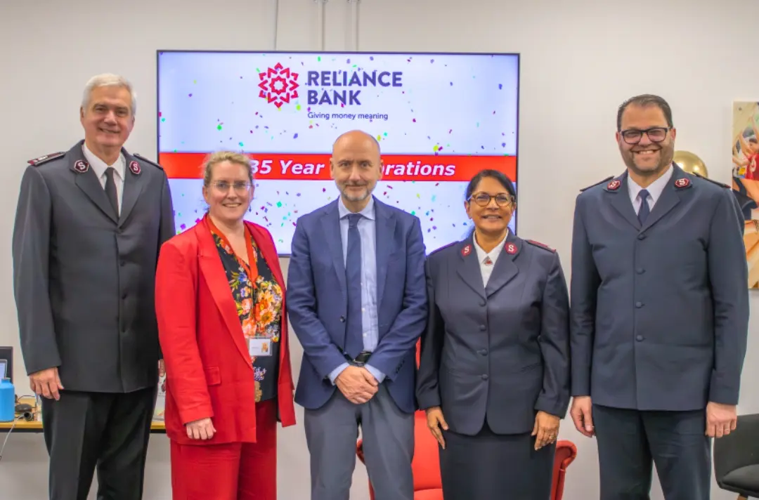 A photo shows people celebrating 135 years of Reliance Bank.