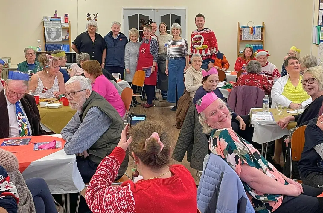 A photo shows a community Christmas meal at Braintree Corps.