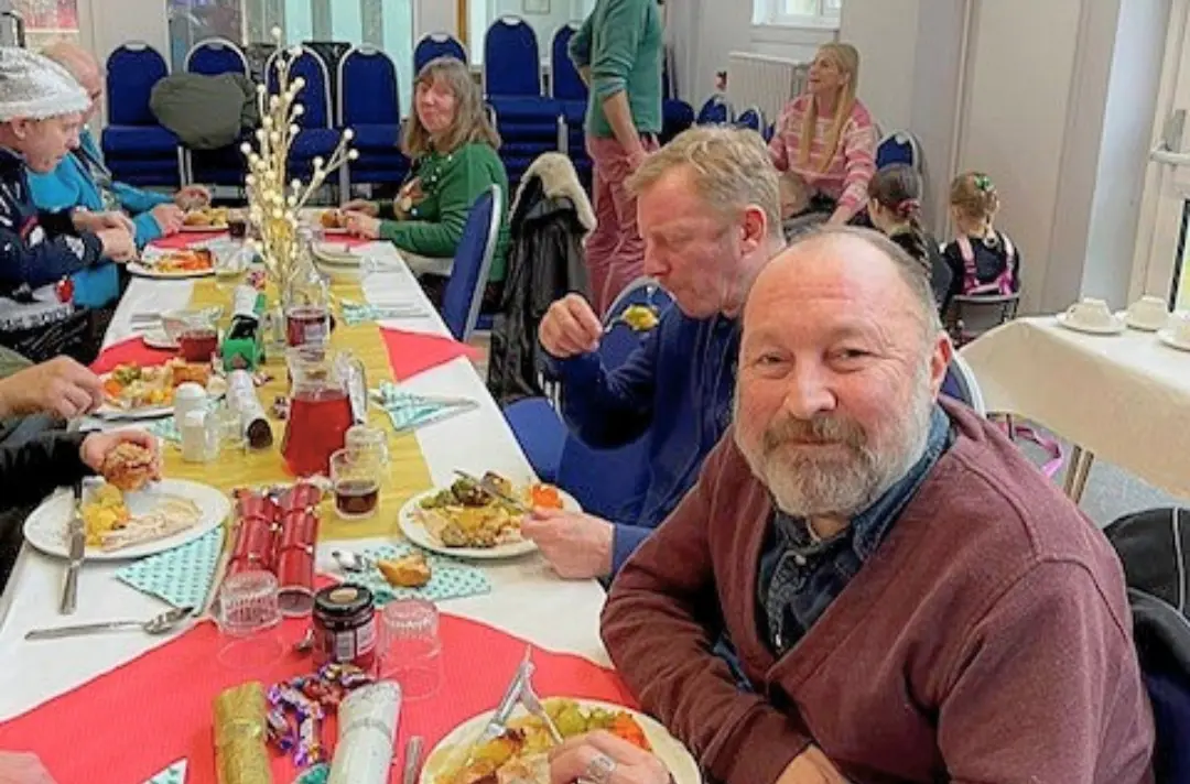 A photo shows a community meal at Hemel Hempstead Corps.