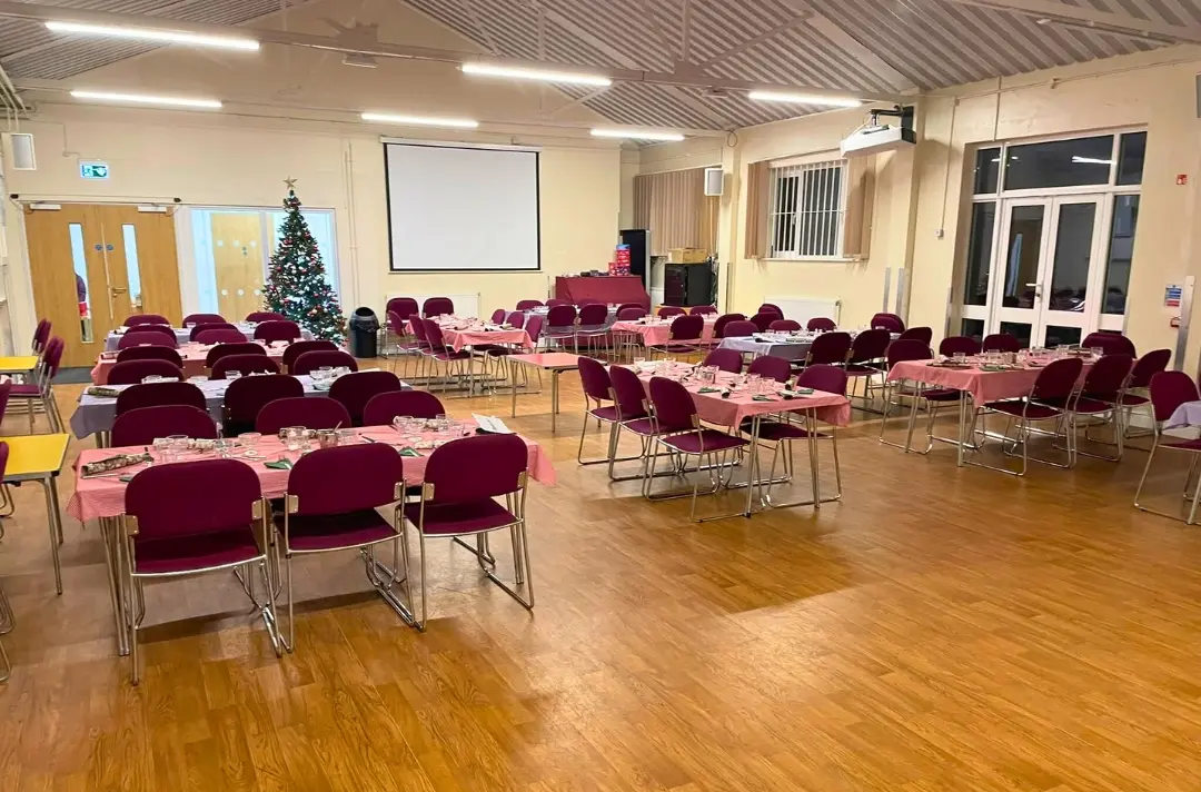 A photo shows a room set up for a community Christmas meal at Staple Hill Corps.