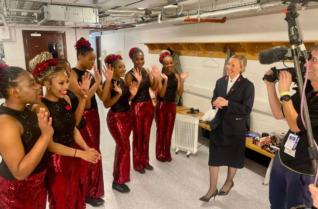 Clapton Dance Group in red sequin outfits backstage with Karen Barber