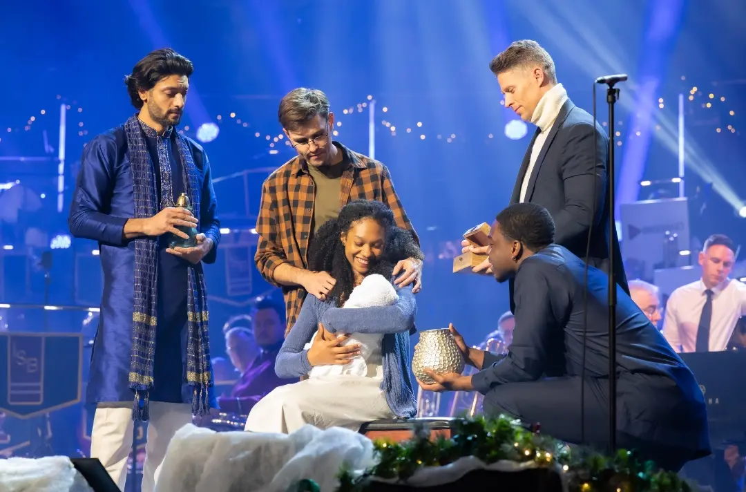 A photo shows people creating a Nativity scene at Celebrating Christmas with The Salvation Army.