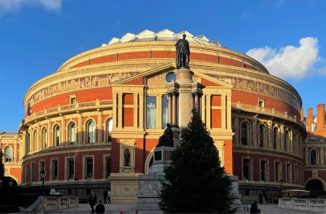 The outside of the Royal Albert Hall in London, featuring blue skies