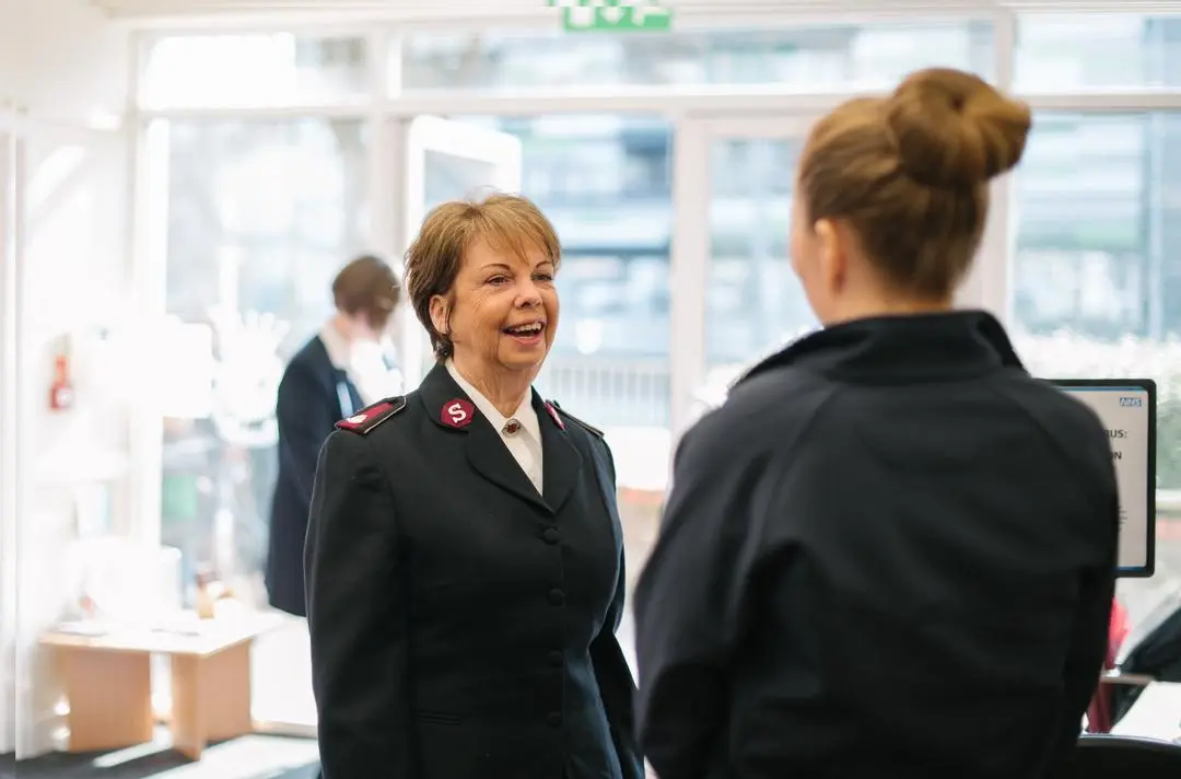 A Salvation Army officer having a conversation with a person