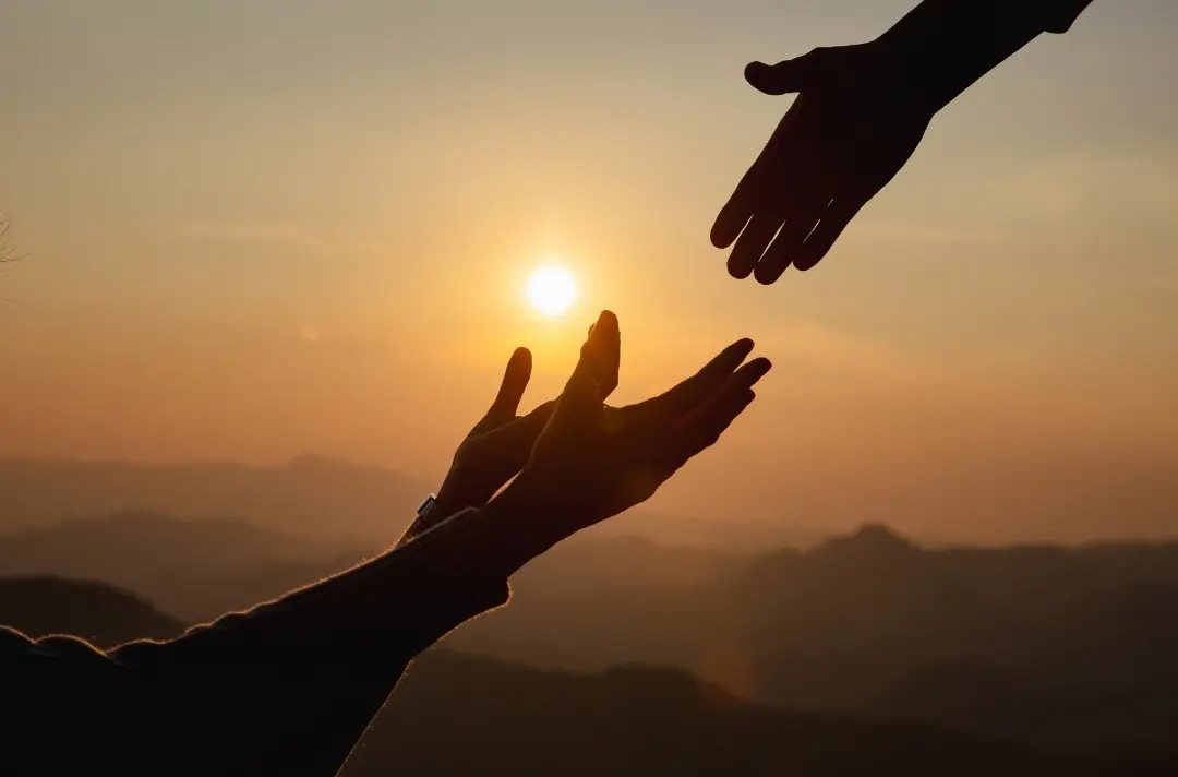A picture of a hand reaching down to help another person