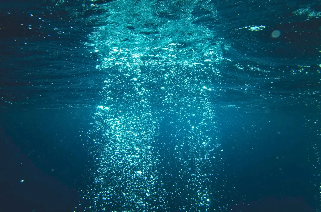 A photo shows deep water that has been recently disturbed by someone diving through.