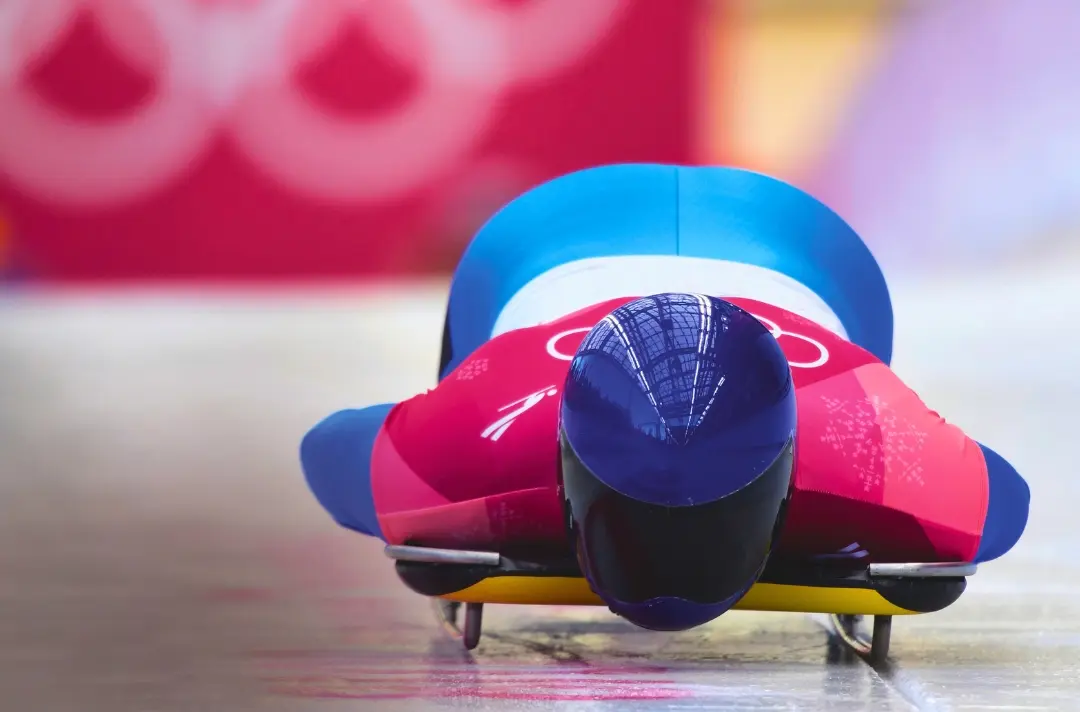 A photo shows someone starting an Olympic skeleton run.