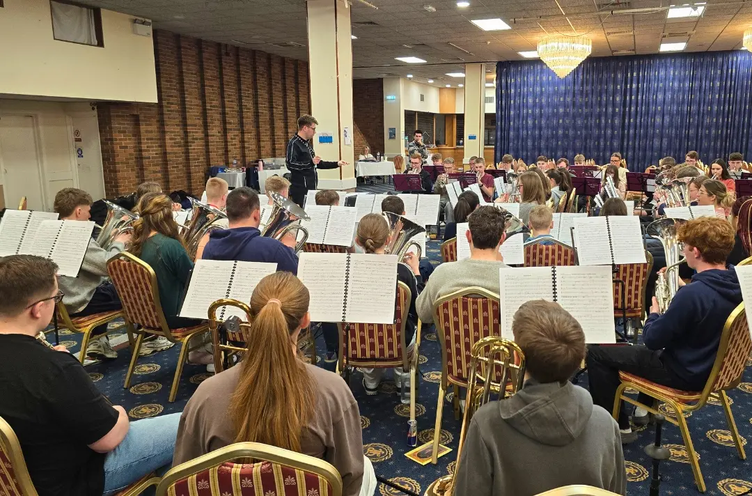 A photo shows a rehearsal at Territorial Youth Band.