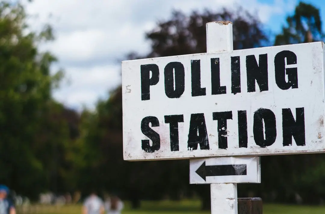A public sign indicating where the polling station is.
