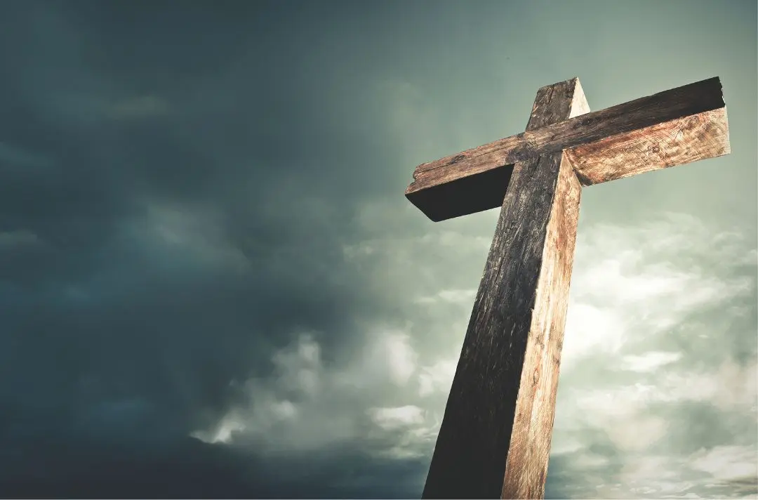 A cross against the backdrop of a dark, stormy sky.