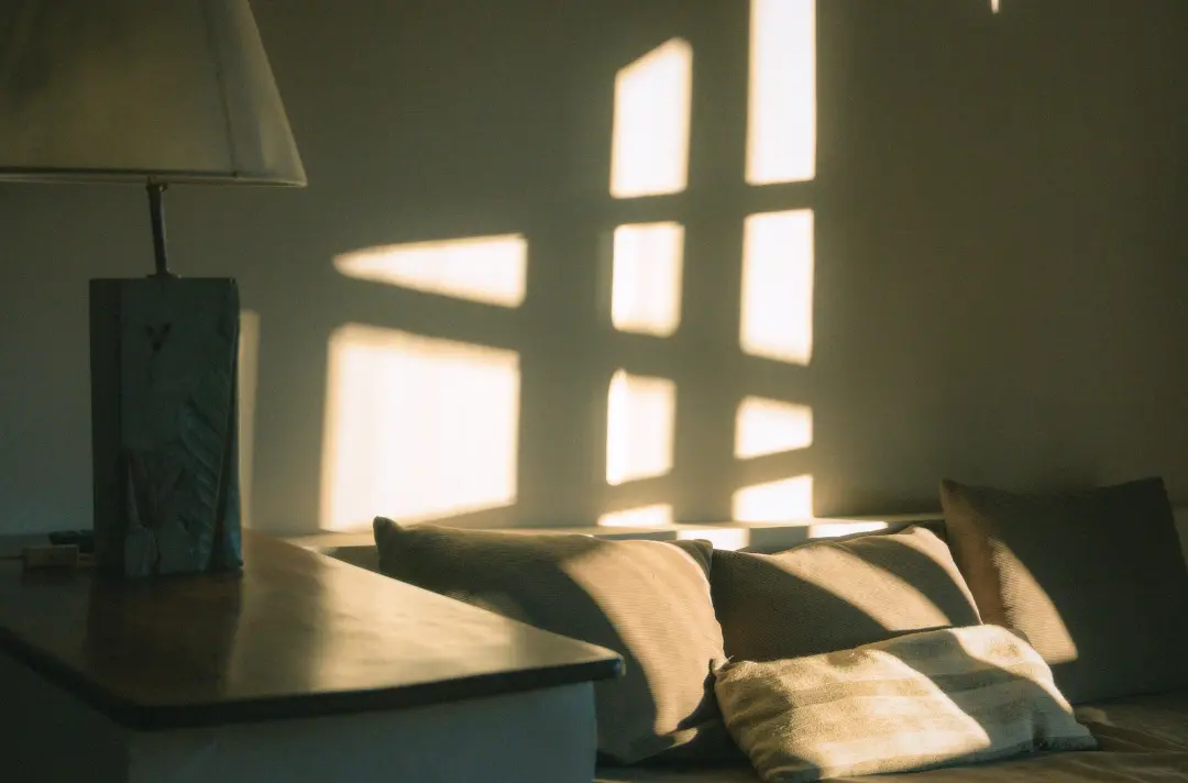A photo shows a comfy room with sunlight streaming in.