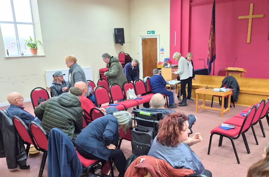 A photo shows a prayer meeting at Bridlington Corps.