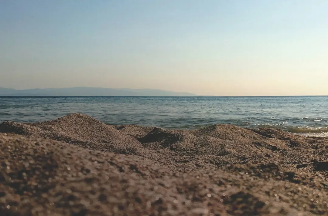 A beach scene overlooking the water