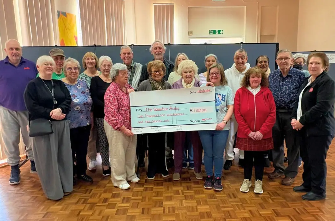 A photo shows a cheque being presented at Croydon Citadel.
