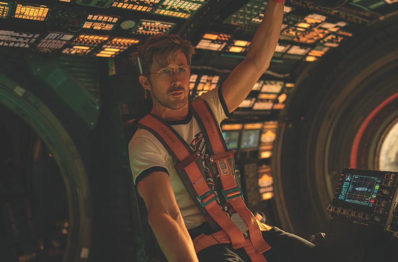 A photo of actor Ryan Gosling portraying the character Dr Ryland Grace sitting inside a space ship.