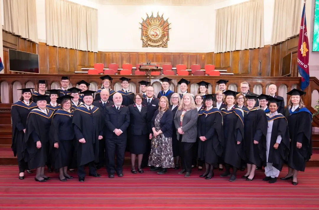 Group photo of staff and students from the graduation ceremony.