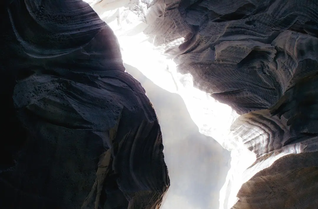 A photo shows light shining past the stone at the entrance of Jesus' tomb.