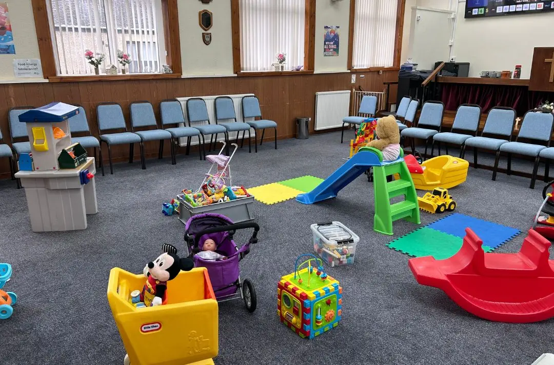 Toys, dolls and teddy bears lay on the floor of the play area at Cowdenbeath Corps hall.