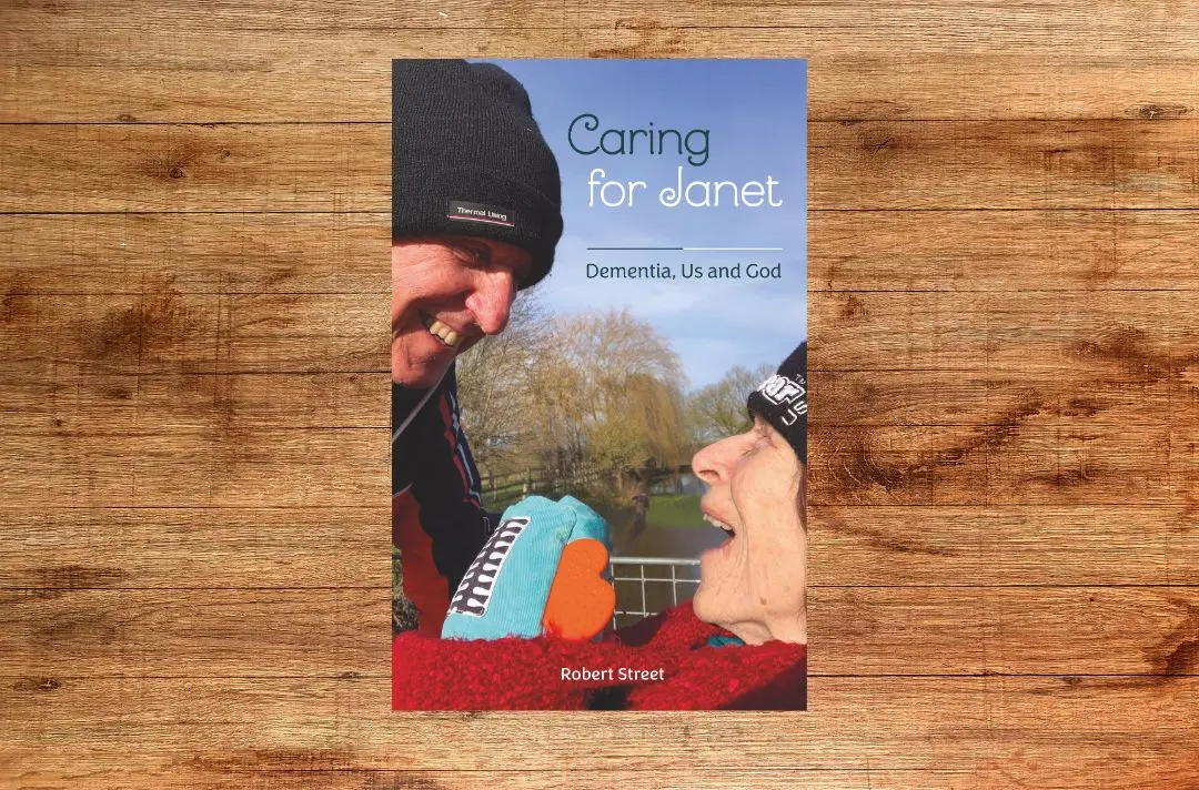 The front cover of Caring for Janet depicting Janet and Bob smiling together.