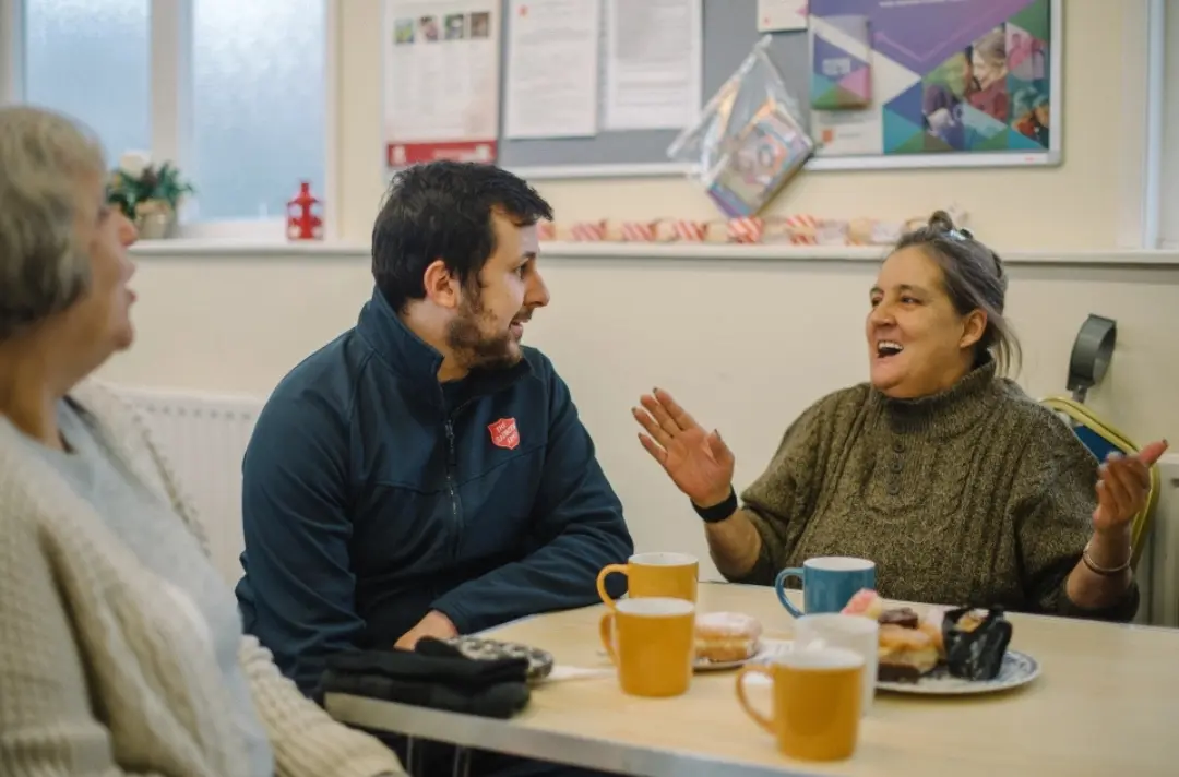 An image of a member of the Salvation Army talking to someone