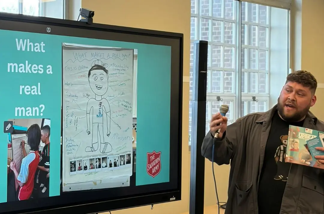 A man gives a presentation on 'what makes a real man?'