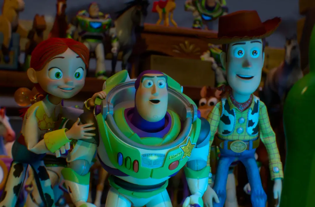 Animated toy characters gathered in a bedroom, including a space ranger toy in a green and white suit at the centre, with a cowboy toy and a red-haired toy beside it. 