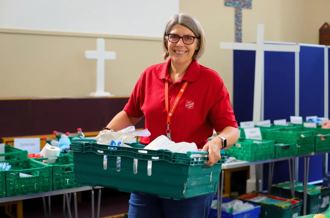 A photo shows Salvation Army staff at Deptford food bank sorting out items.