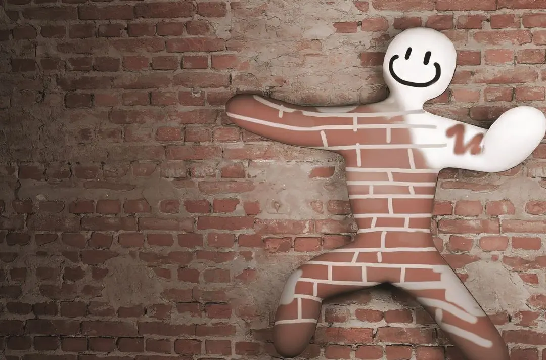 An outline of a person blending into a brick wall.